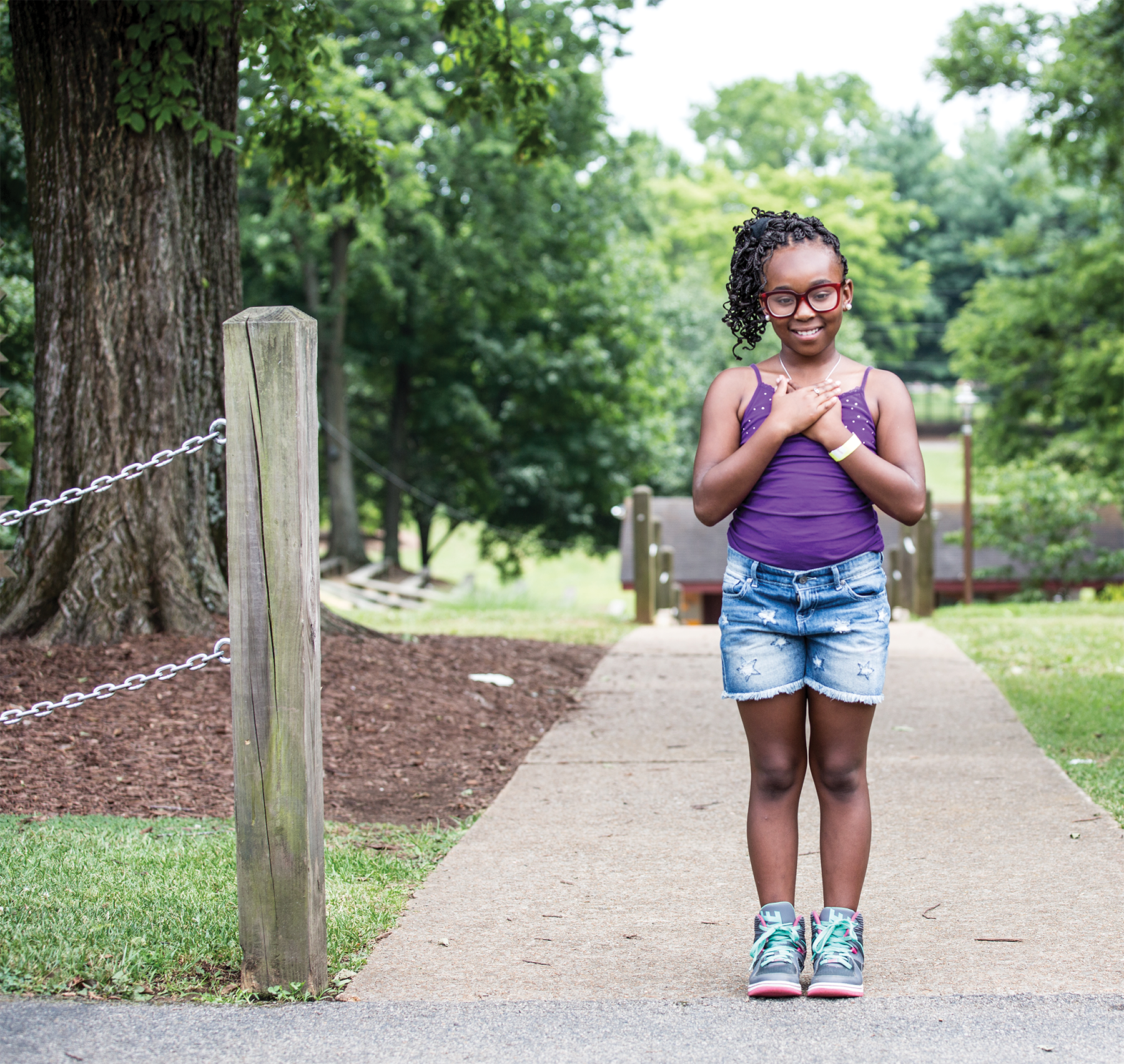 Image of a female 4-H student with hands over heart